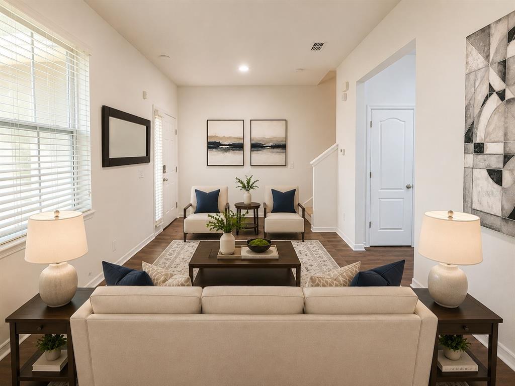 A living room features a sofa, two armchairs, a coffee table, and two lamps — 12210 LANGSTAFF DRIVE, WINDERMERE, FL