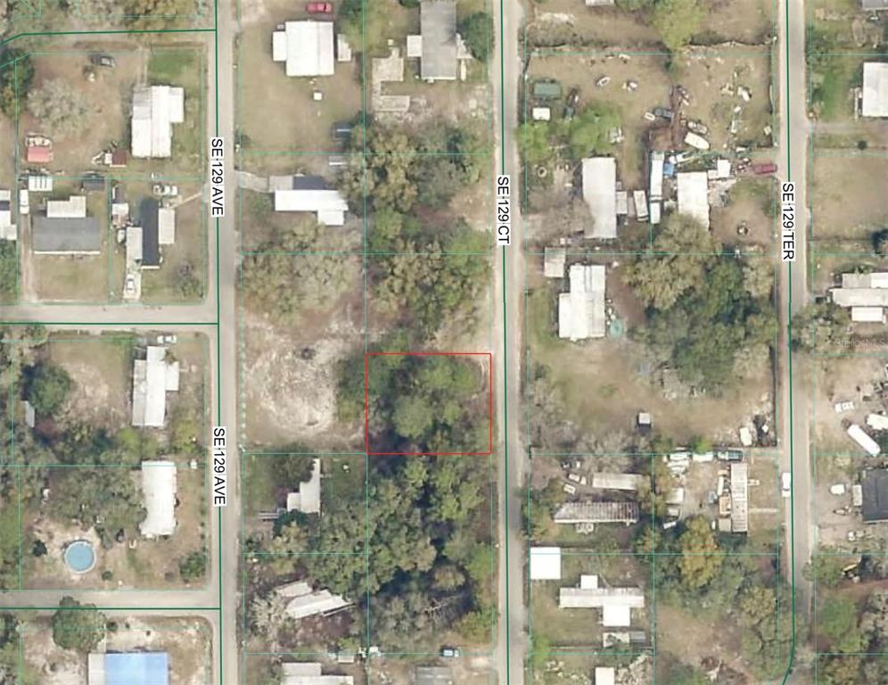 This is an aerial map showing a vacant, wooded lot outlined in red — TBD SE 129 CT, SILVER SPRINGS, FL