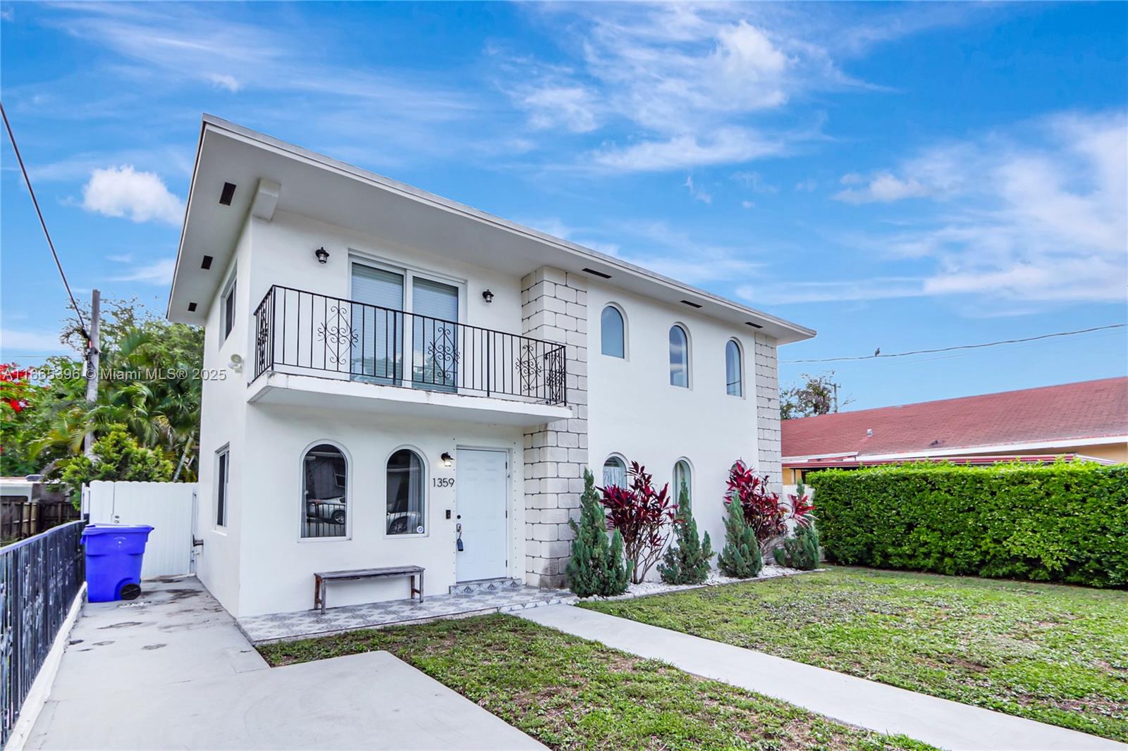 A two-story white house features arched windows, a balcony with black railing, and a stone-accented facade — 1359 SW 11th St, Miami FL 33135, MIAMI, FL