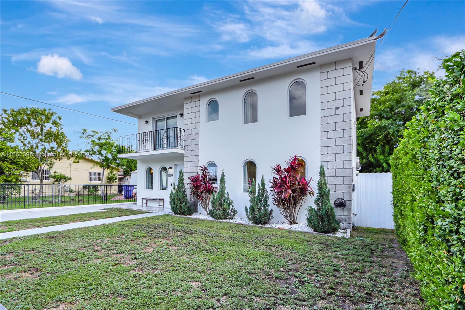 A two-story house with white stucco walls, arched windows, and a balcony — 1359 SW 11th St, Miami FL 33135, MIAMI, FL