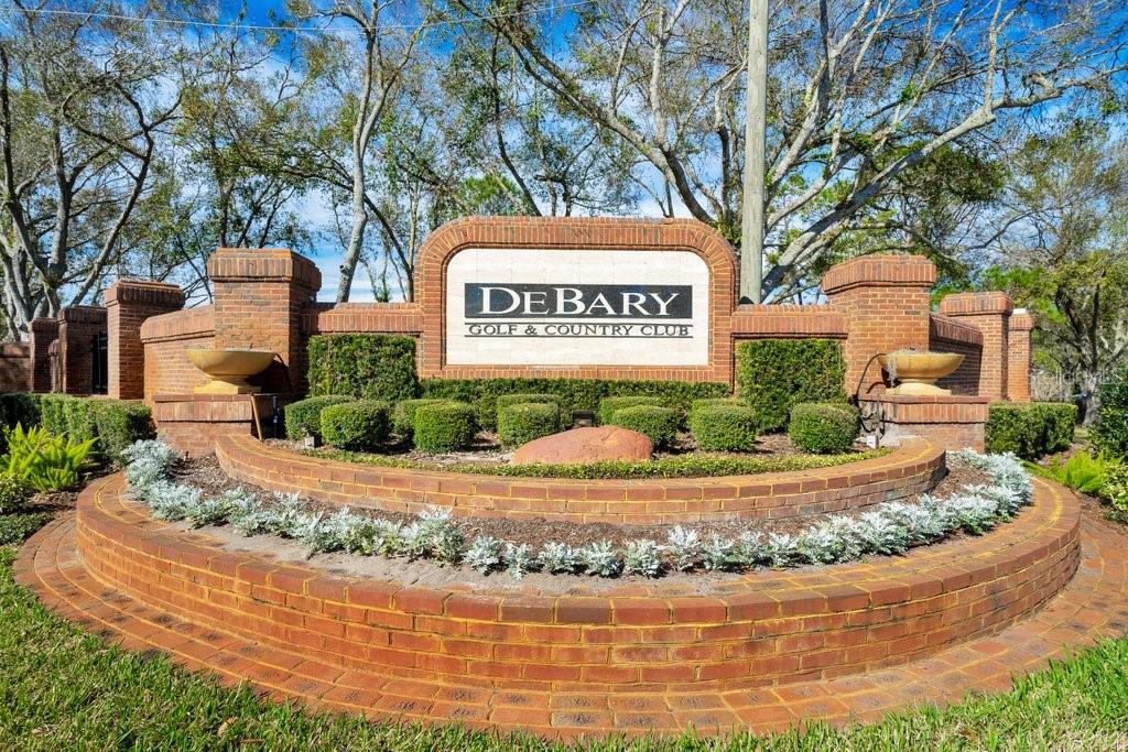 A brick monument sign for the DeBary Golf & Country Club sits in a garden — 208 LAMONTE POINT CT, DEBARY, FL