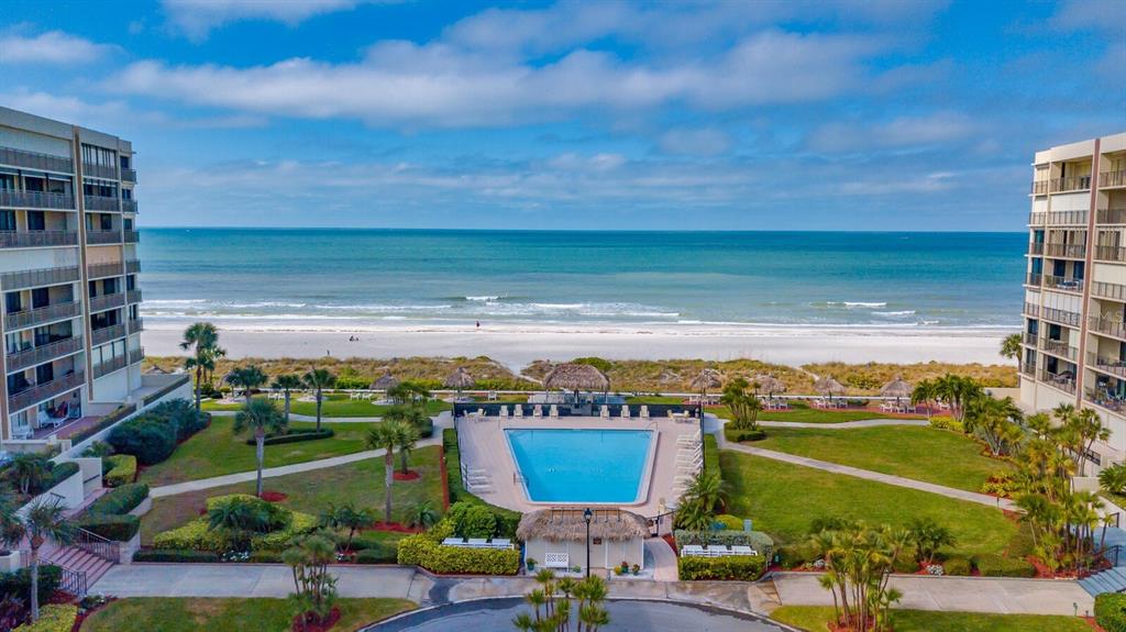 An aerial view of a beachfront swimming pool situated between two multi-story residential buildings — 1430 GULF BOULEVARD UNIT 612, CLEARWATER BEACH, FL