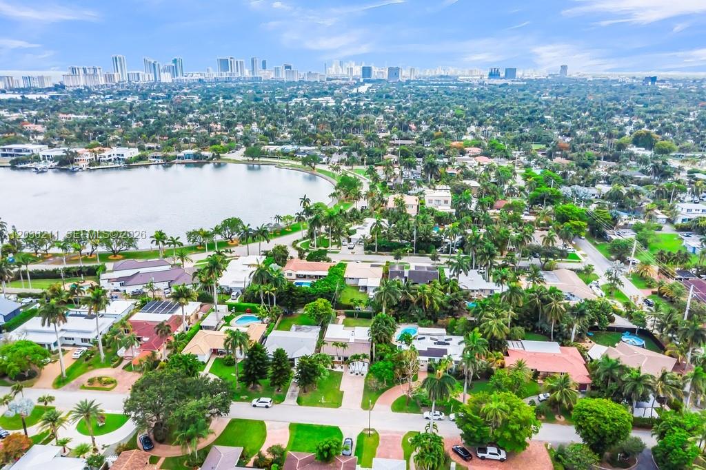 An aerial view of a suburban neighborhood with houses, palm trees, and a lake — 1234 Buchanan St, Hollywood FL 33019, HOLLYWOOD, FL