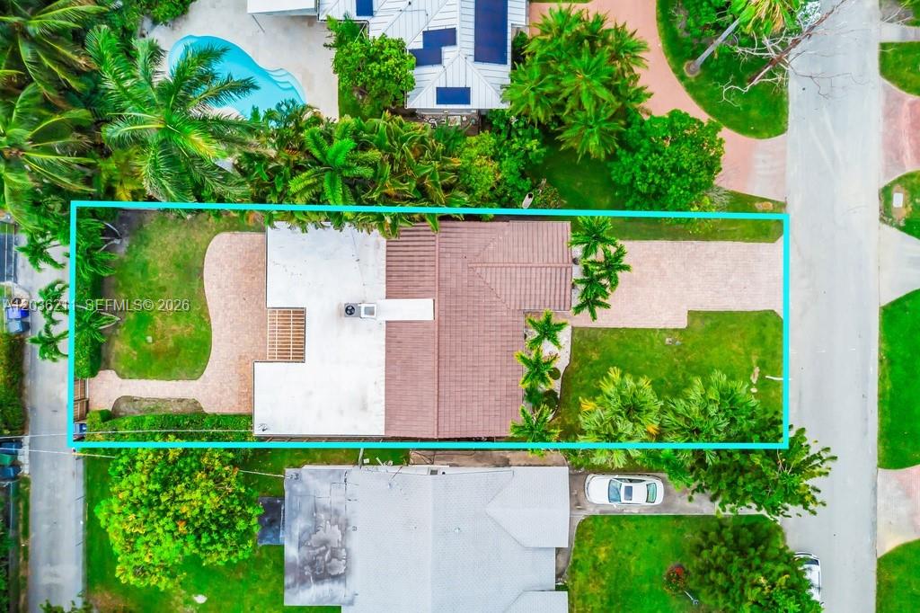 An aerial view shows a house with a tiled roof, paved driveway, and landscaped yard — 1234 Buchanan St, Hollywood FL 33019, HOLLYWOOD, FL