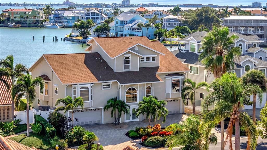 An aerial view of a multi-story waterfront house with a brown roof and palm trees — 5918 SKIMMER POINT BOULEVARD S, GULFPORT, FL