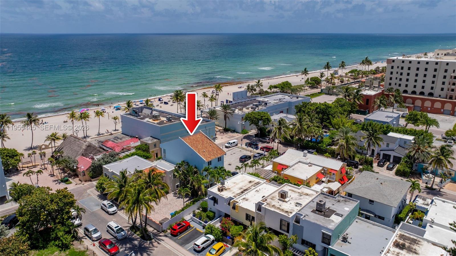 An aerial view shows a light blue house with a red roof near the beach — 311 N Surf Rd, Hollywood FL 33019, HOLLYWOOD, FL