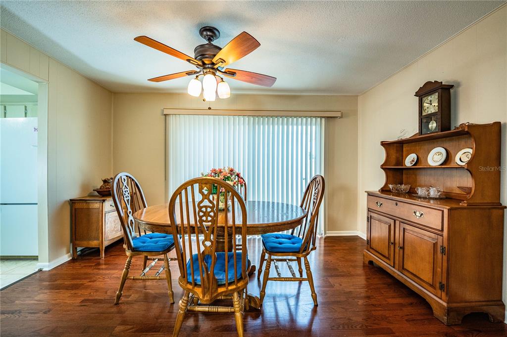 A single-story white house with a tiled roof and a covered carport — 652 COTTAGE LANE, LAKELAND, FL