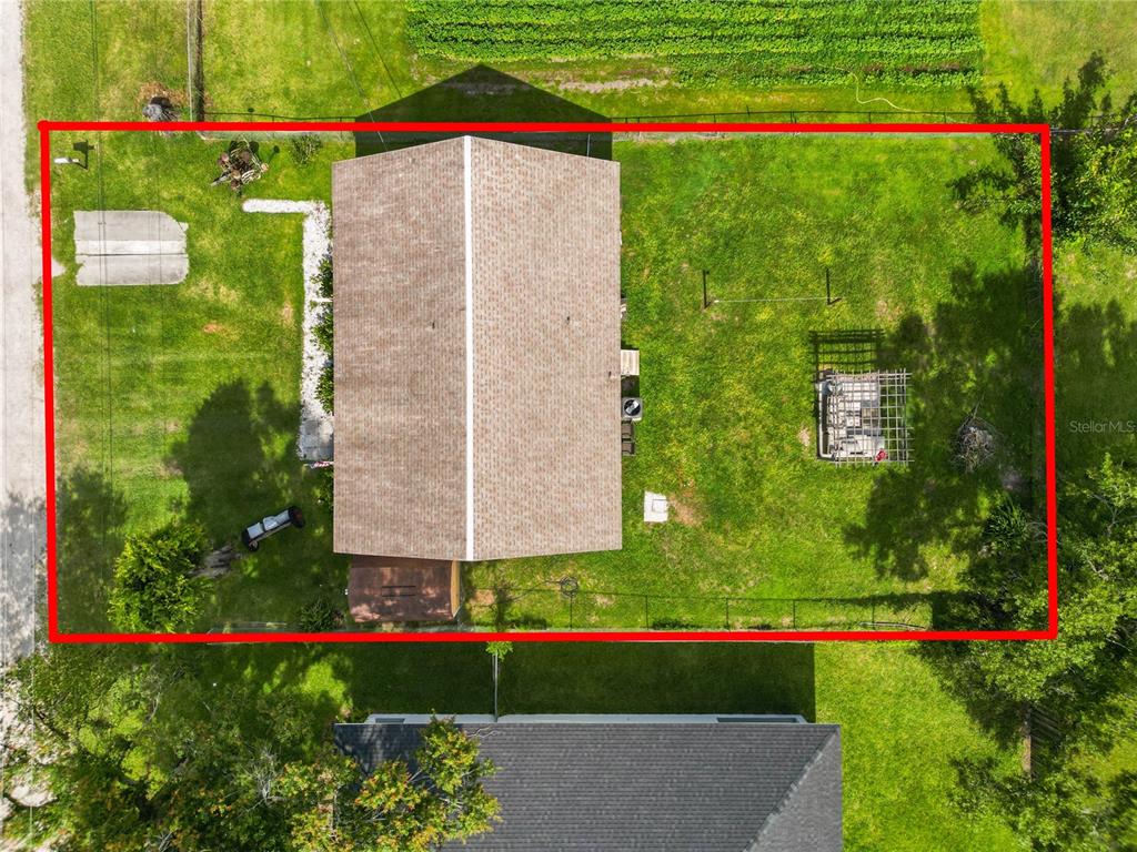 An aerial view shows a house with a brown roof centered on a fenced lot — 2001 W BALL STREET, PLANT CITY, FL