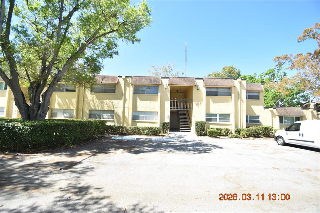 A two-story apartment building with a central staircase and a parking lot in front — 3910 44TH STREET N UNIT C9, ST PETERSBURG, FL