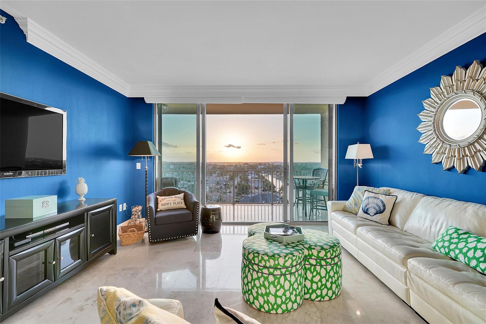 An aerial view shows a waterfront apartment building with a pool and surrounding city skyline — 821 N Riverside Drive, Pompano Beach FL 33062, POMPANO BEACH, FL