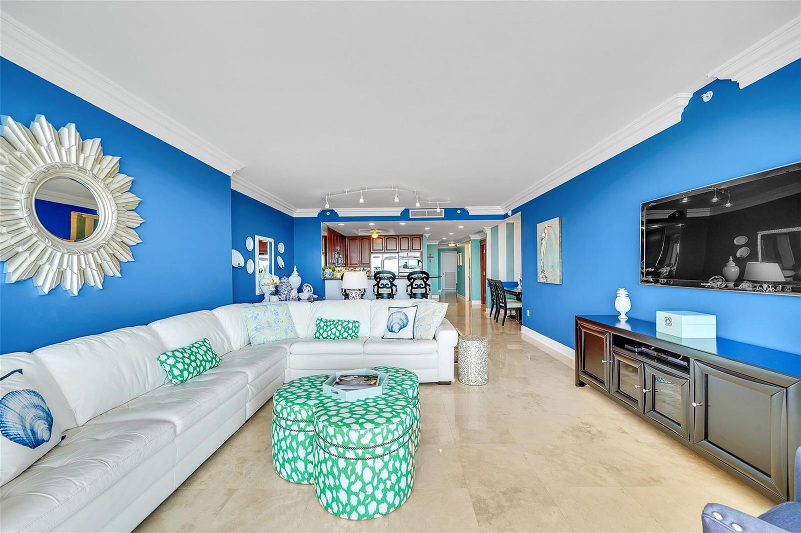 A living room features bright blue walls, a white sectional sofa, and a green ottoman — 821 N Riverside Drive, Pompano Beach FL 33062, POMPANO BEACH, FL