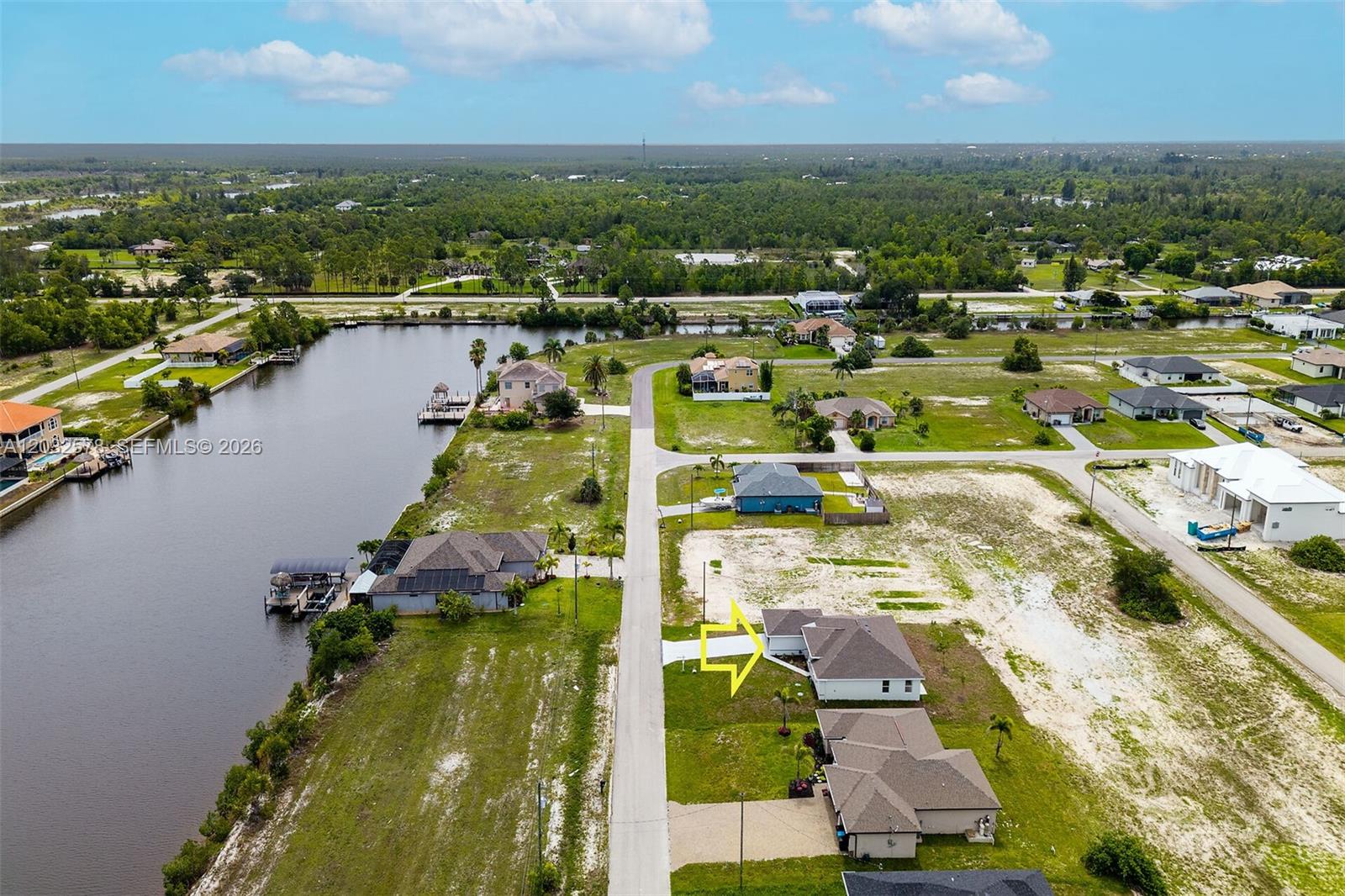 An aerial view shows a residential street with houses, a canal, and a yellow arrow — 4130 NW 33rd, Cape Coral FL 33993, CAPE CORAL, FL