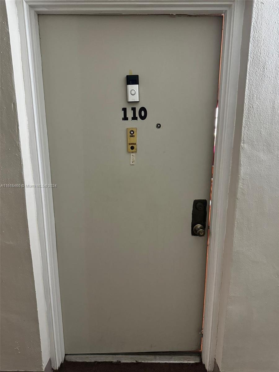 A light-colored apartment door labeled 110 features a doorbell camera and a standard handle — 4047 NW 16th St # 110, Lauderhill FL 33313, LAUDERHILL, FL