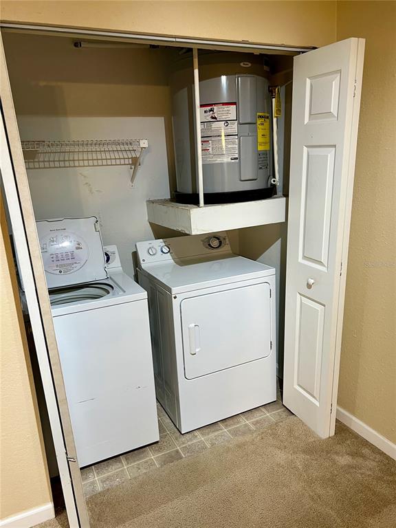 A kitchen features wood cabinets, dark granite countertops, and stainless steel appliances — 375 LAKE ONTARIO COURT UNIT 203, ALTAMONTE SPRINGS, FL