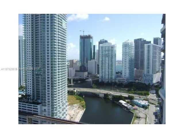 An elevated view of a city skyline with high-rise buildings, a river, and a bridge — 185 SW 7th St # 1909, Miami FL 33130, MIAMI, FL