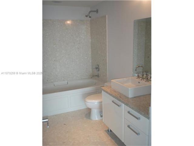 A bathroom features a white vanity with a vessel sink, a toilet, and a bathtub — 185 SW 7th St # 1909, Miami FL 33130, MIAMI, FL
