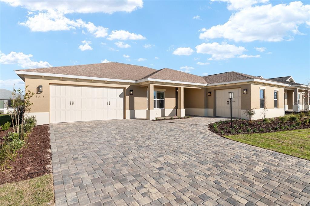 A single-story house with a paved driveway, two garage doors, and a covered entryway — 8515 SW 101ST TERRACE, OCALA, FL