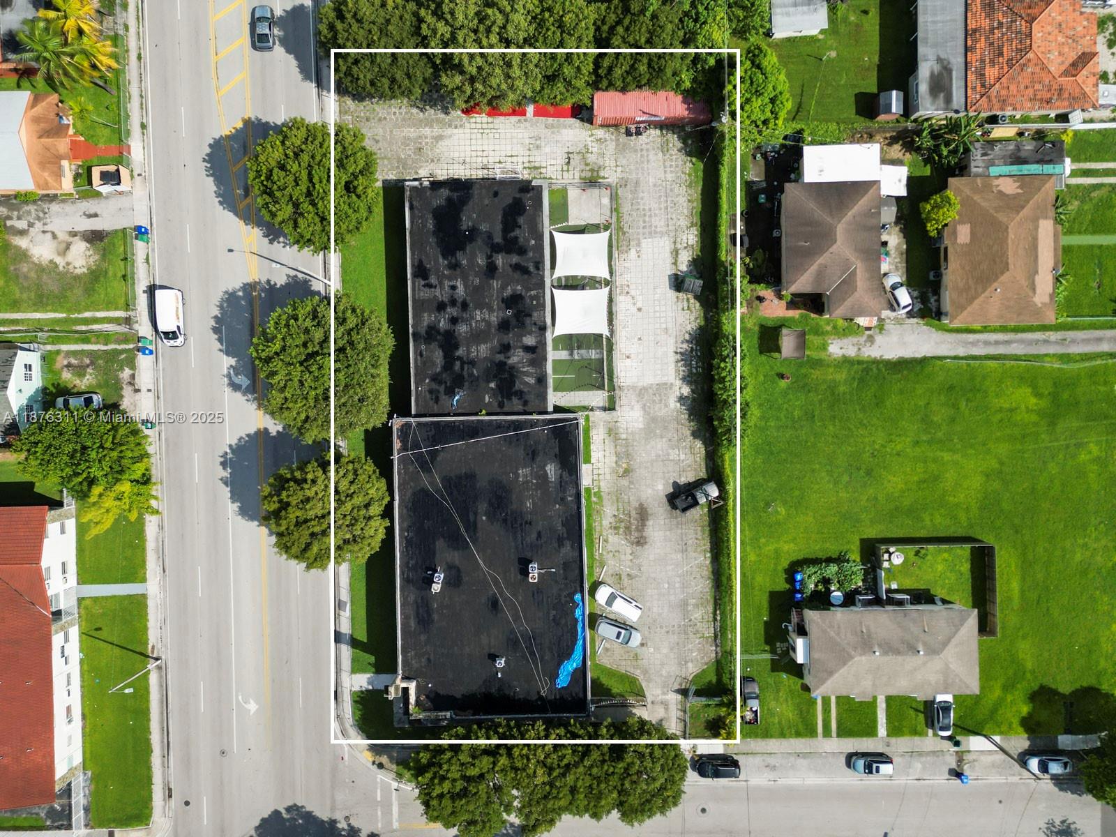 An aerial view shows a commercial property with two flat-roofed buildings and a paved lot — 3001 NW 22nd Ave, Miami FL 33142, MIAMI, FL