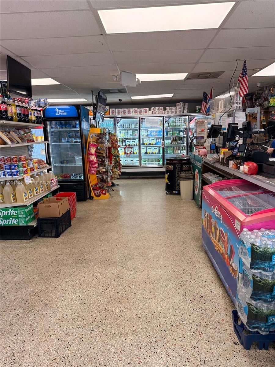 A convenience store interior features refrigerated display cases, snack aisles, and a checkout counter — 3381 NW 7th St, Miami FL 33125, MIAMI, FL