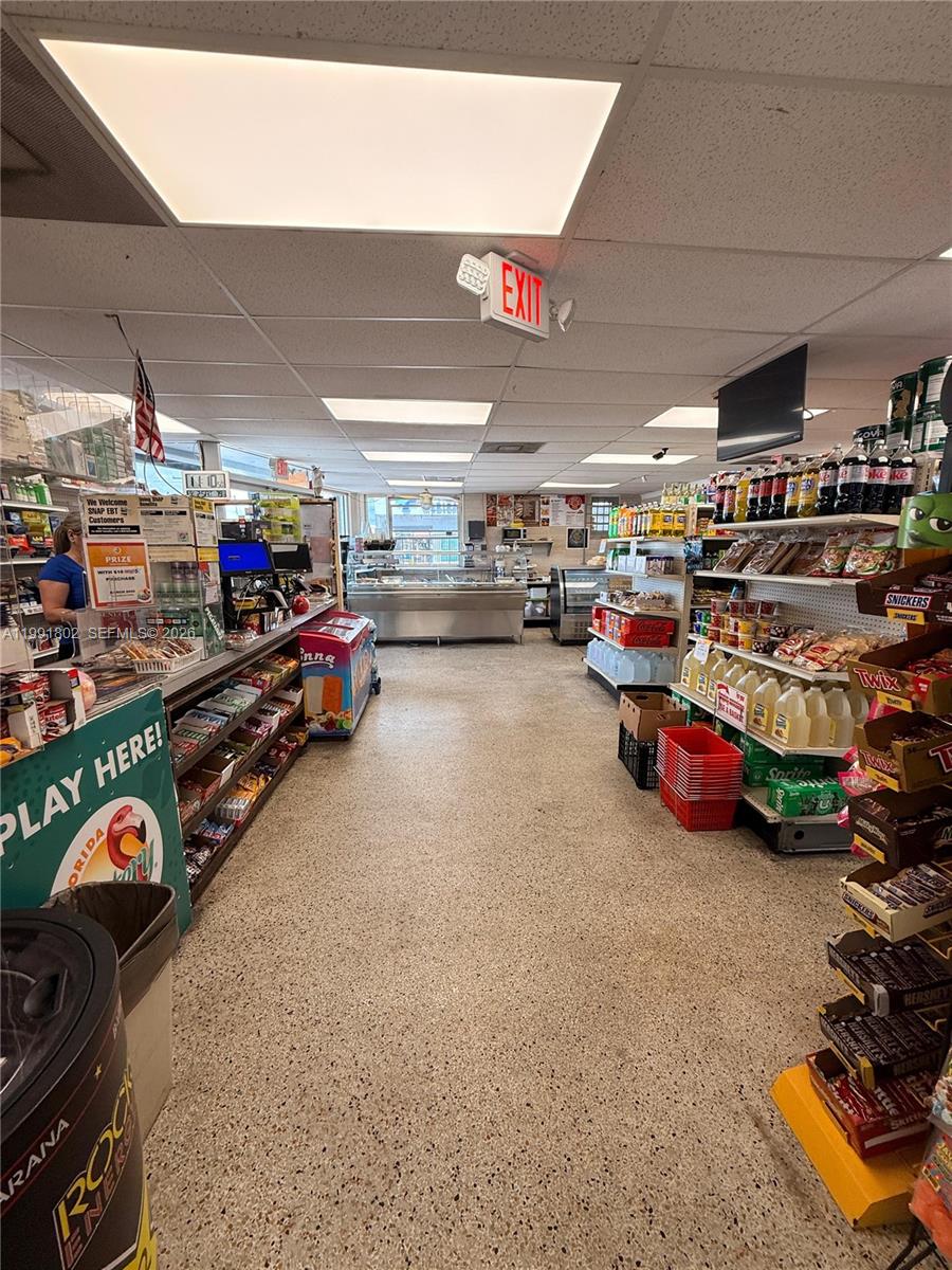 A convenience store interior features aisles of stocked shelves, a deli counter, and tile flooring — 3381 NW 7th St, Miami FL 33125, MIAMI, FL