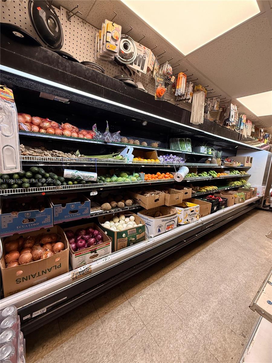 A grocery store produce aisle features refrigerated shelves stocked with fresh fruits and vegetables — 3381 NW 7th St, Miami FL 33125, MIAMI, FL