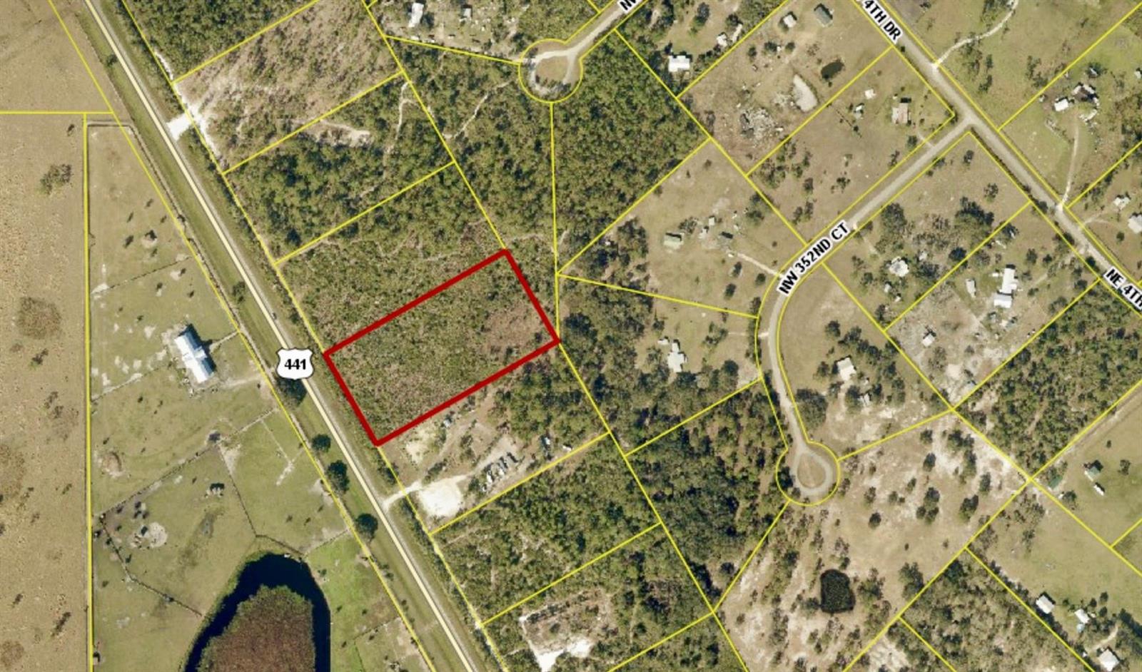 An aerial map view shows a rectangular parcel of land outlined in red along a highway — 34964 N Hwy 441, Okeechobee FL 34972, OKEECHOBEE, FL