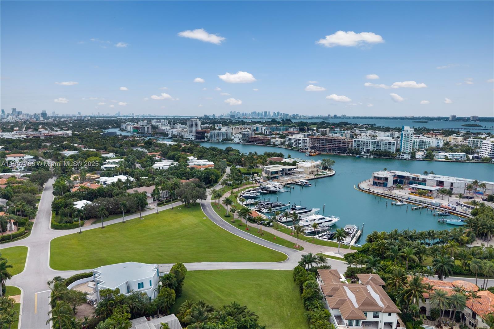 An aerial view shows a waterfront neighborhood with a marina, green lawns, and city skyline — 145 Harbour Way Lots 2 and 3, Bal Harbour FL 33154, BAL HARBOUR, FL