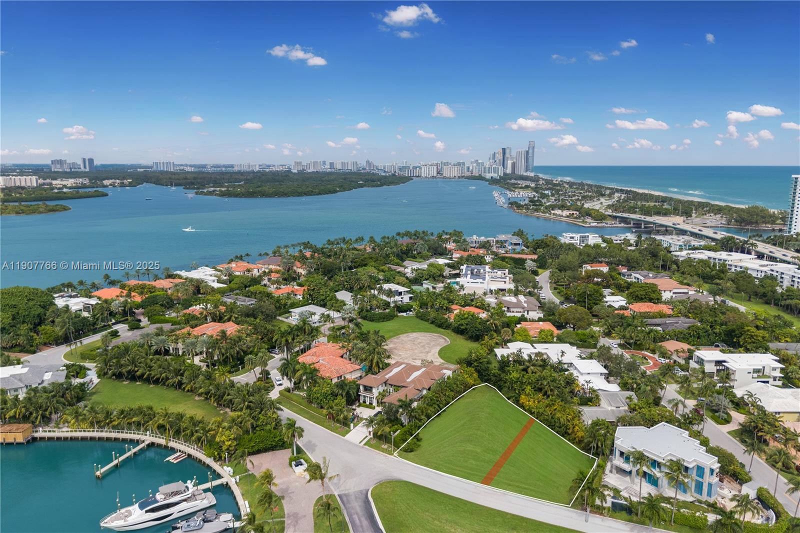 An aerial view shows a vacant, grass-covered residential lot outlined in white near a waterfront — 145 Harbour Way Lots 2 and 3, Bal Harbour FL 33154, BAL HARBOUR, FL