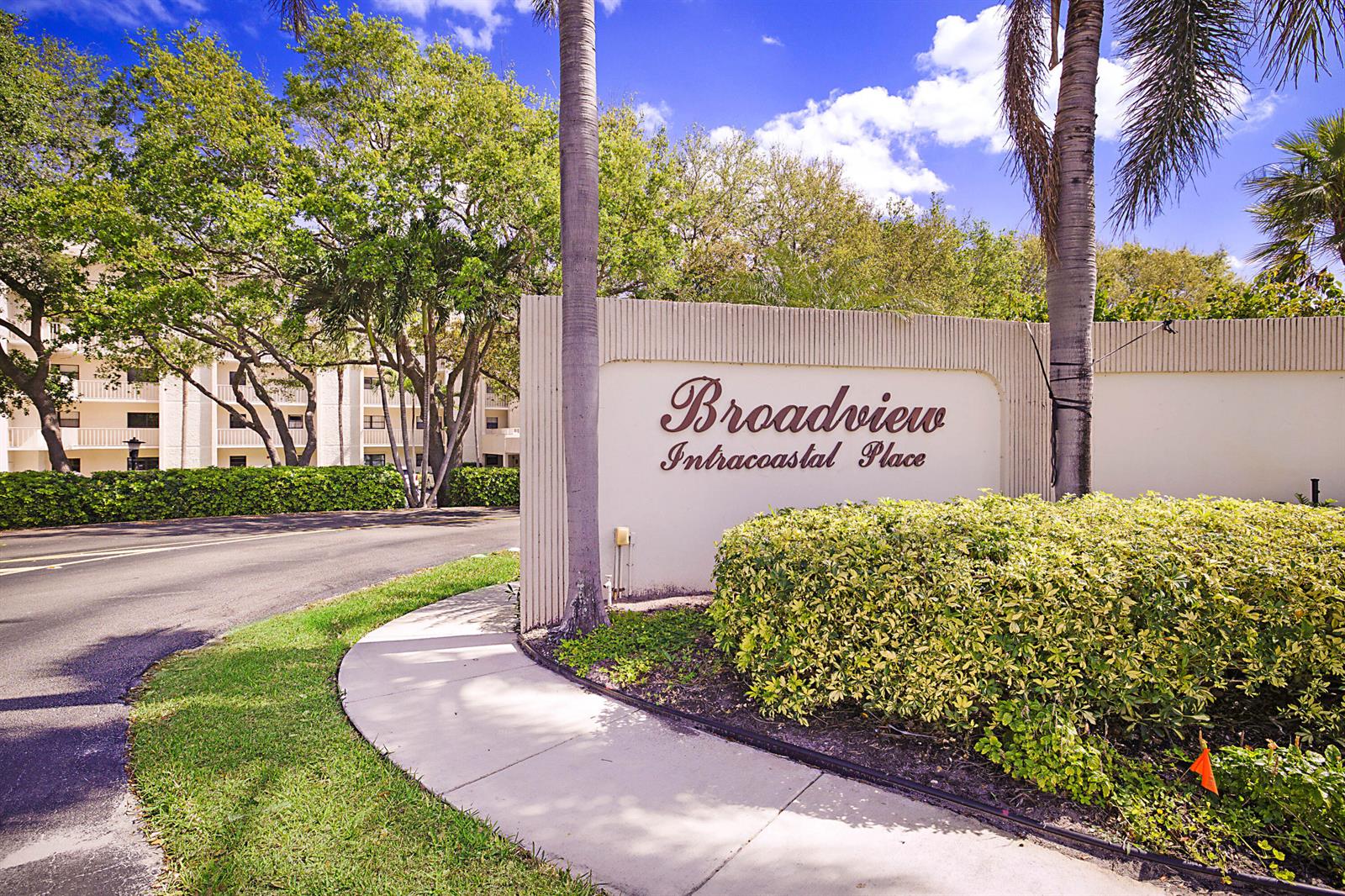 The entrance sign for Broadview Intracoastal Place stands beside a paved road and palm trees — 300 Intracoastal Place # 101, Jupiter FL 33469, JUPITER, FL