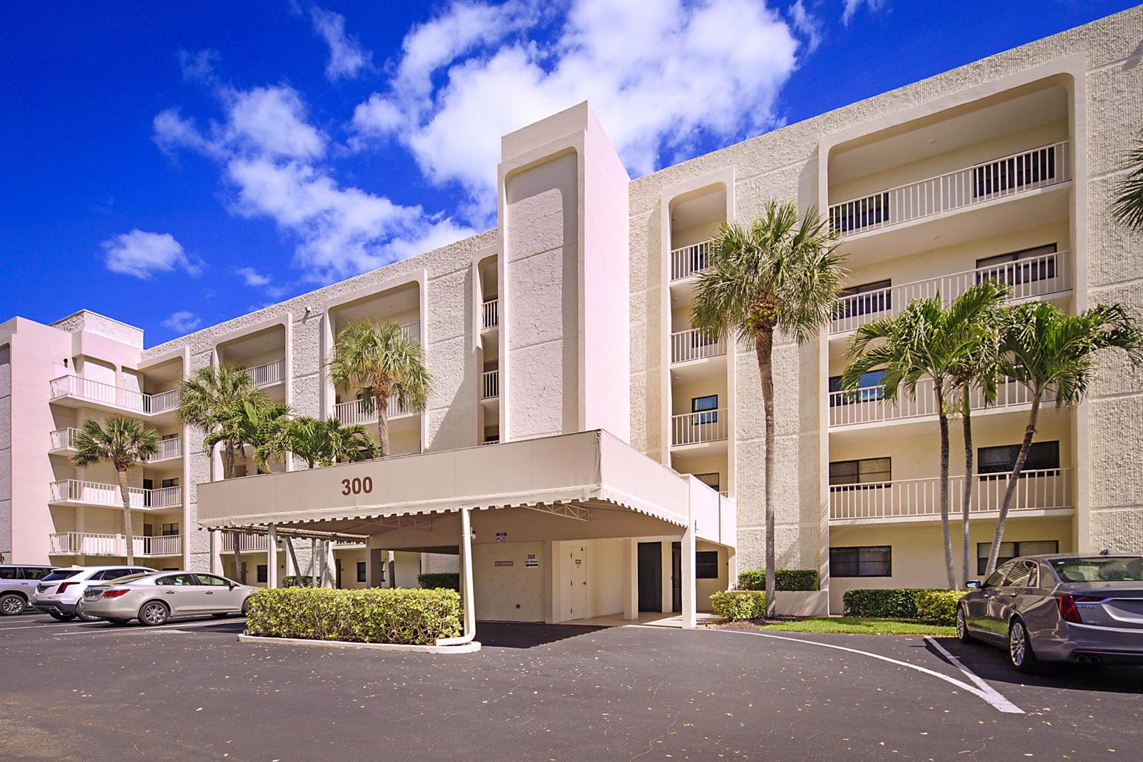 A multi-story apartment building with a covered entrance, balconies, and palm trees in the parking lot — 300 Intracoastal Place # 101, Jupiter FL 33469, JUPITER, FL
