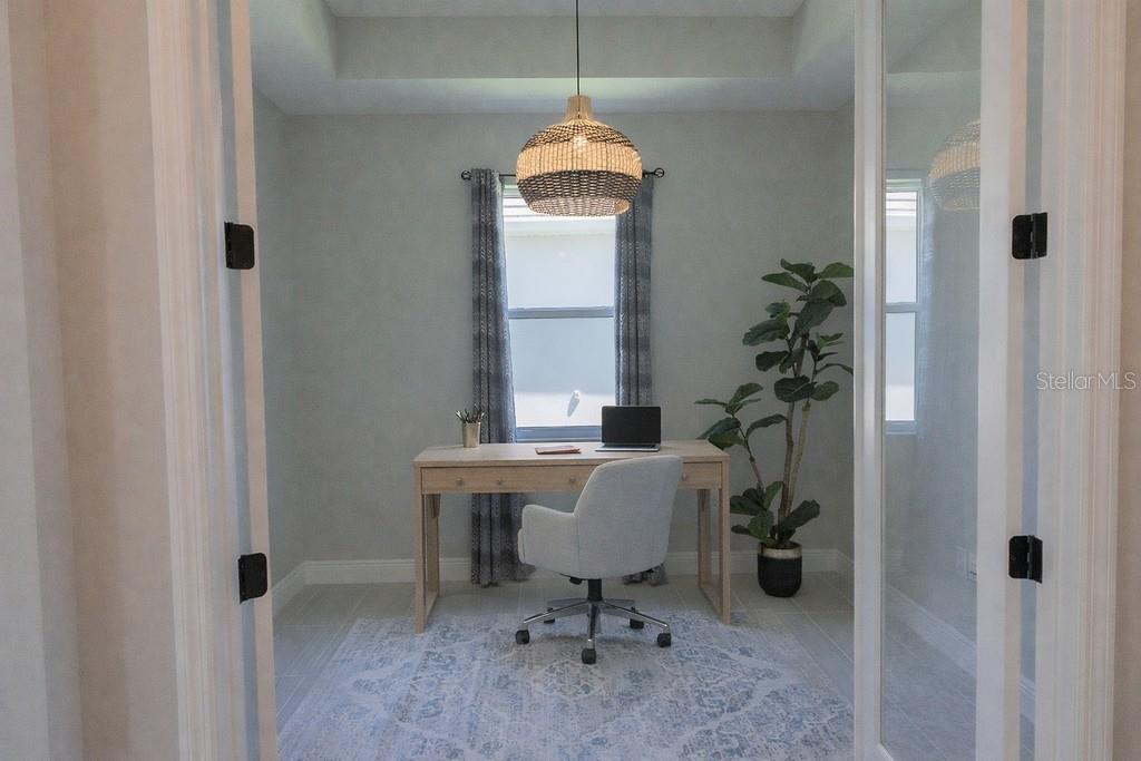 A home office features a wooden desk, an upholstered chair, and a woven pendant light — 8100 SLIPWAY DRIVE, SARASOTA, FL