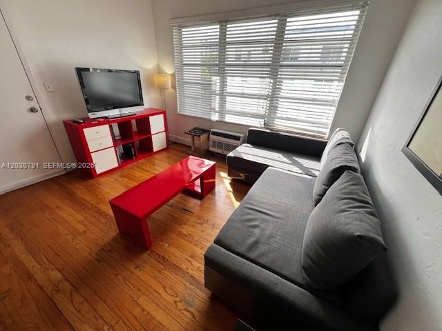 A living room features a grey sofa, a red coffee table, and a red media console — 601 7th St # 4, Miami Beach FL 33139, MIAMI BEACH, FL