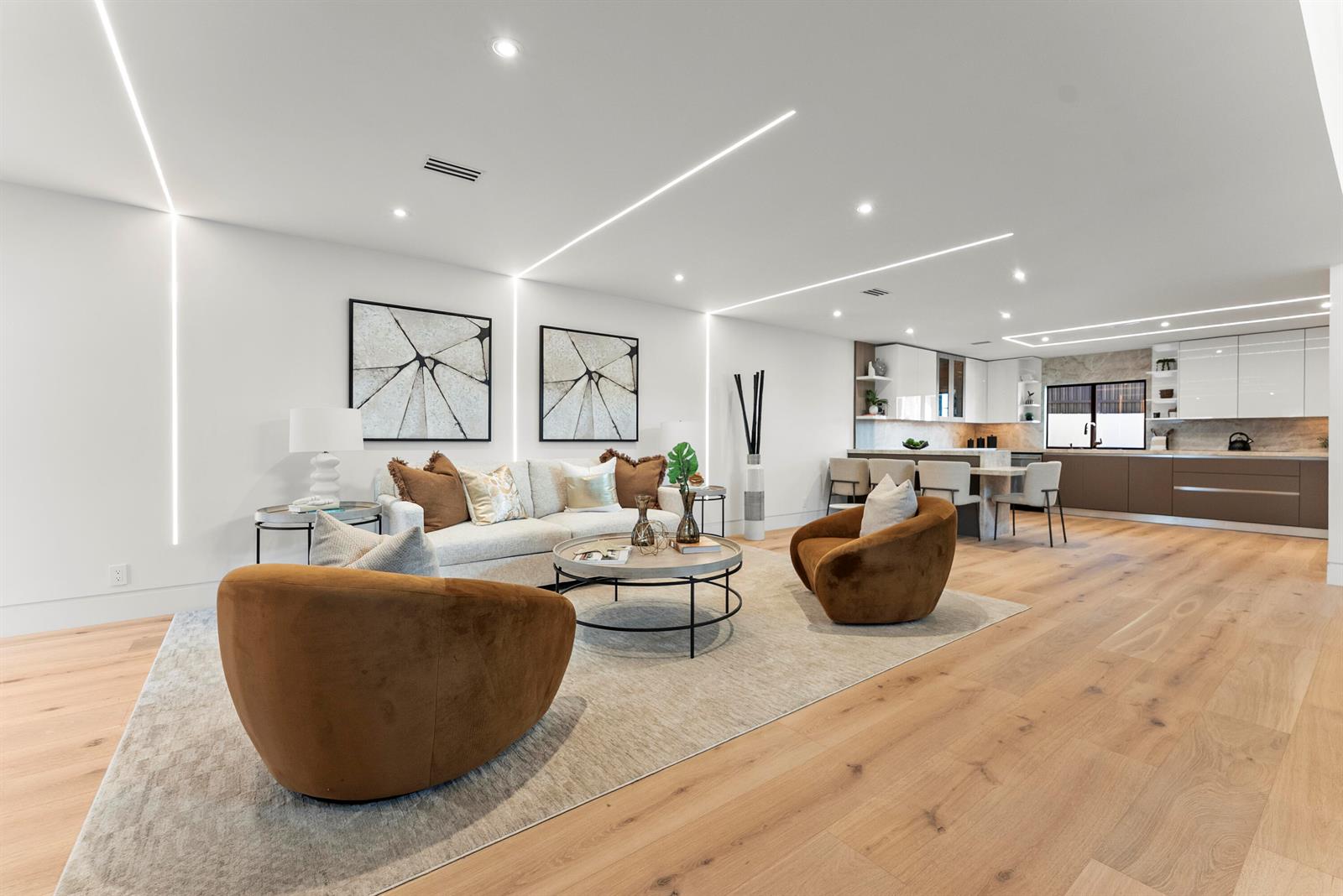 A modern open-concept living room and kitchen with light wood floors and recessed lighting — 1690-1692 S Ocean Boulevard, Delray Beach FL 33483, DELRAY BEACH, FL