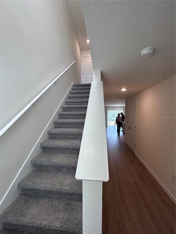 An entryway features a white six-panel door, wood-look flooring, and a carpeted step — 760 PRESTON COVE DRIVE, ST CLOUD, FL