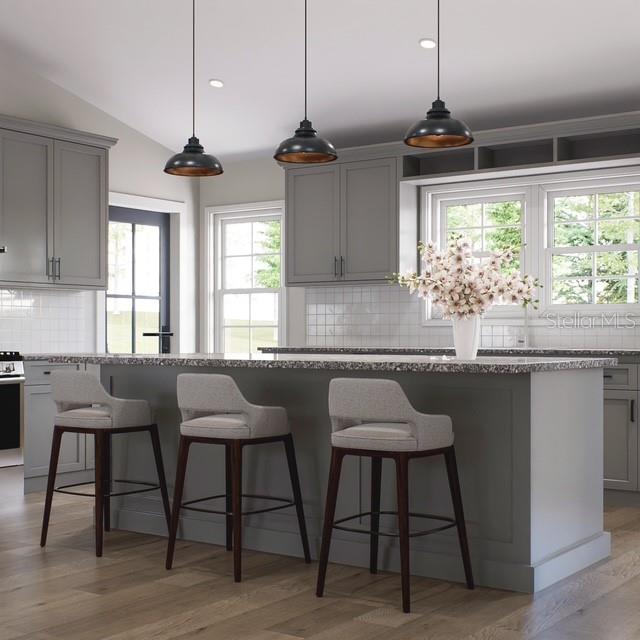 This rendering shows a kitchen with gray cabinets, a central island, and three pendant lights — 354 HOOT OWL ROAD, SATSUMA, FL
