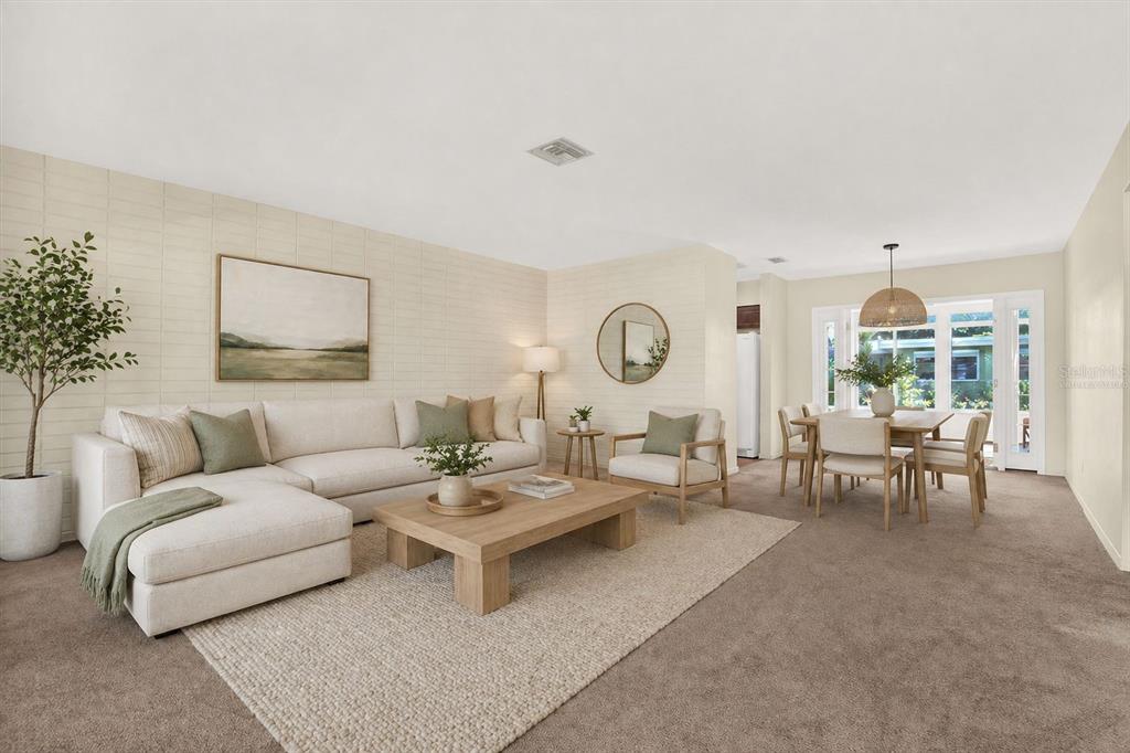A living room and dining area with neutral furniture, a textured wall, and carpeted floors — 2561 58TH STREET N, ST PETERSBURG, FL