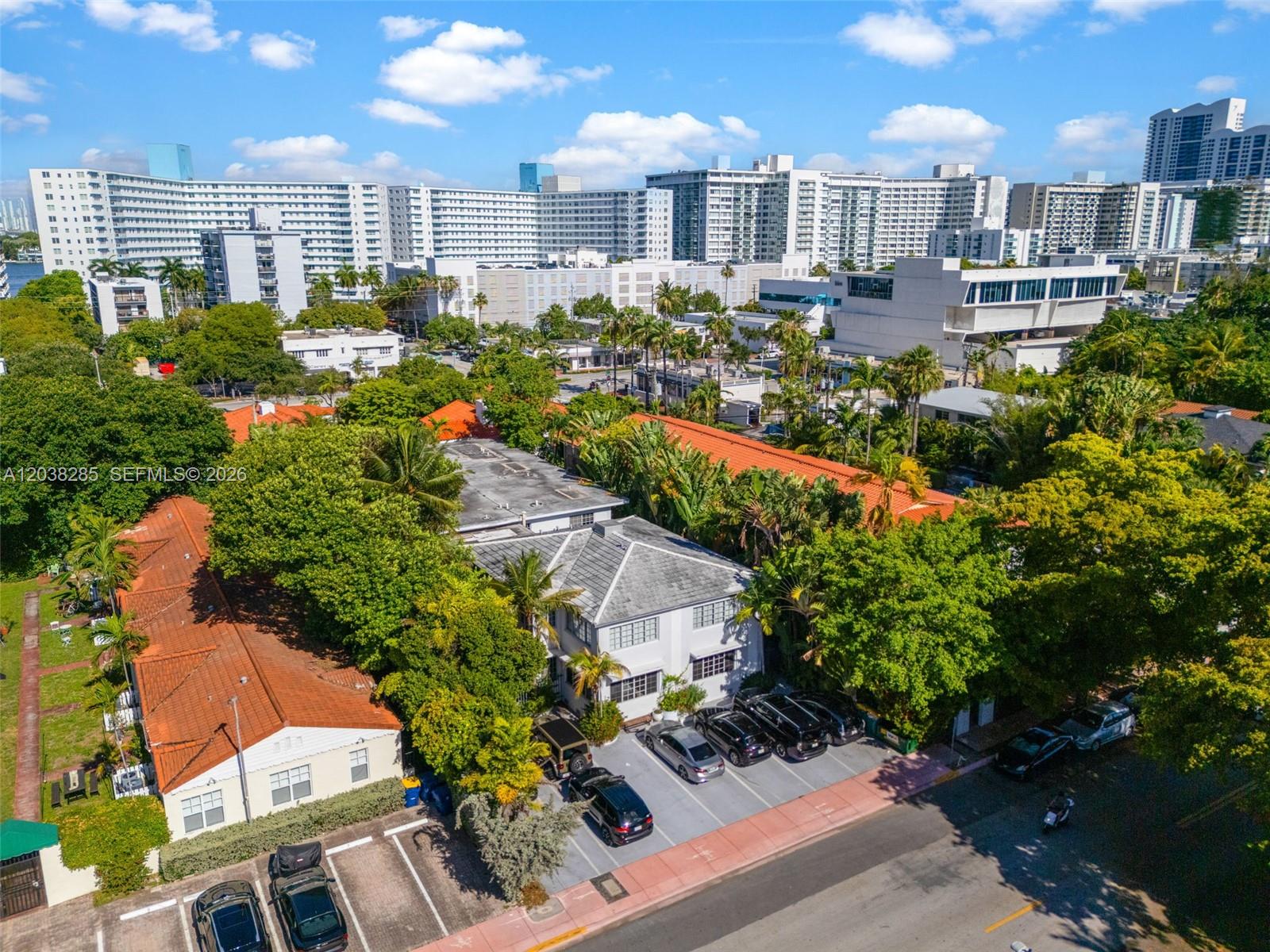 An aerial view shows a multi-story building with a parking lot and surrounding trees — 840 Lenox Ave # 3, Miami Beach FL 33139, MIAMI BEACH, FL
