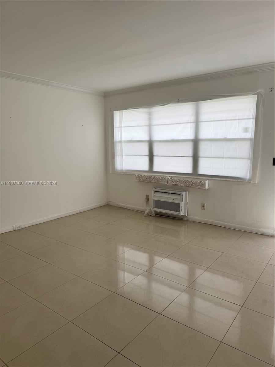 An empty room features white walls, large windows with plastic coverings, and light-colored tile flooring — 162 Westbury J # 162, Deerfield Beach FL 33442, DEERFIELD BEACH, FL