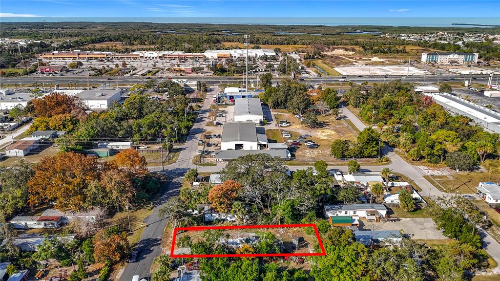 An aerial view shows a rectangular lot outlined in red within a suburban neighborhood — 7135 ELIZABETH AVENUE, HUDSON, FL