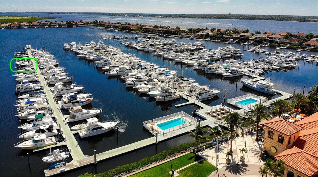 The exterior of the Riviera Dunes Marina Resort building features a yellow stucco facade — 102 RIVIERA DUNES WAY UNIT N-30, PALMETTO, FL