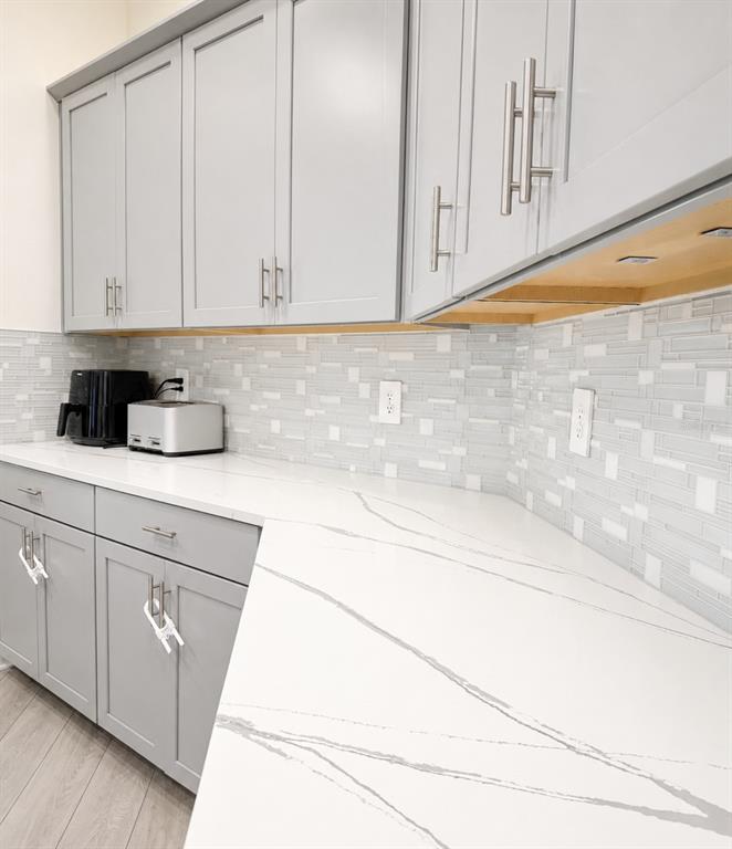 A kitchen features gray shaker cabinets, white quartz countertops, and a light-colored mosaic tile backsplash — 1378 PARK LEAH CIRCLE, APOPKA, FL