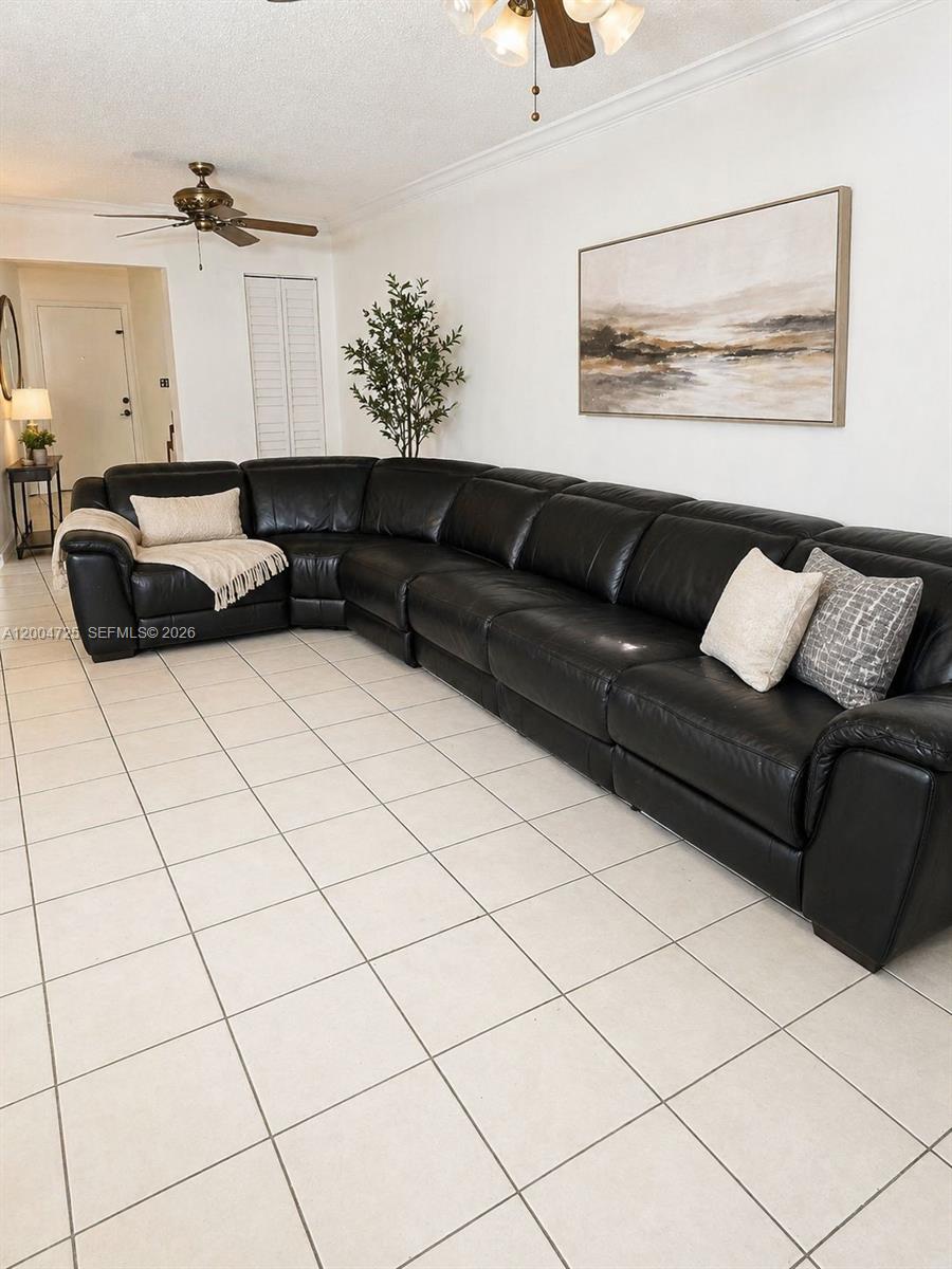 A large black leather sectional sofa sits on a tiled floor in a living room — 1531 NW 80th Ave # I, Margate FL 33063, MARGATE, FL