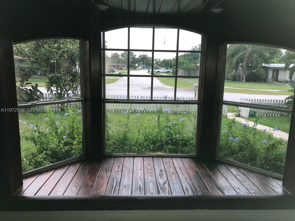 A bay window with a dark wood floor overlooks a front yard and street — 1467 Renton St., Deltona FL 32725, DELTONA, FL