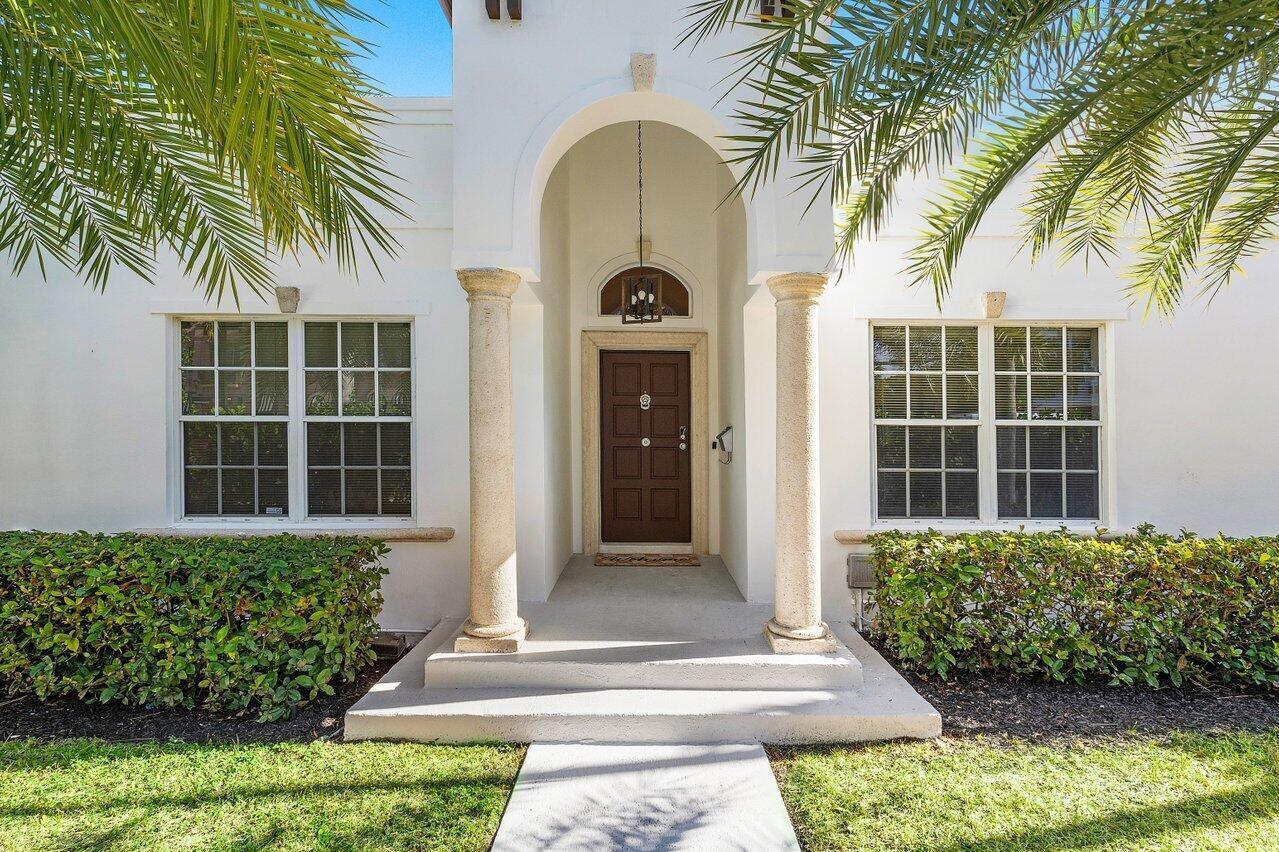 A white house exterior features a brown front door framed by two stone columns — 200 NE 2nd Street, Boca Raton FL 33432, BOCA RATON, FL