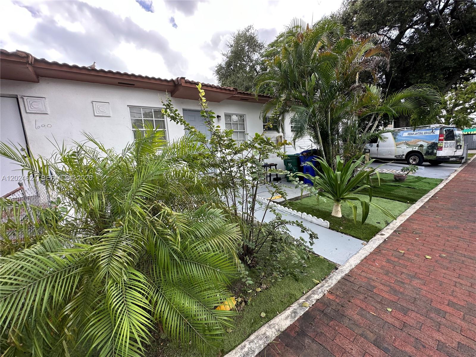 A white single-story house with a palm tree, artificial grass, and a brick sidewalk — 600 SW 16th Ave, Miami FL 33135, MIAMI, FL