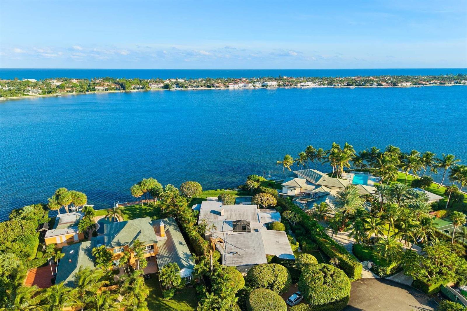 An aerial view of waterfront luxury homes with swimming pools, lush landscaping, and ocean views — 748 Island Drive, Palm Beach FL 33480, PALM BEACH, FL
