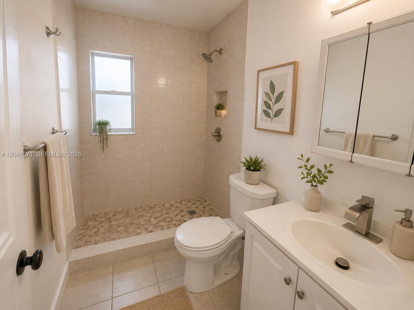 A bathroom features a tiled walk-in shower with a pebble floor, toilet, and vanity — 3810 SW 89th Ave # 3810, Miami FL 33165, MIAMI, FL