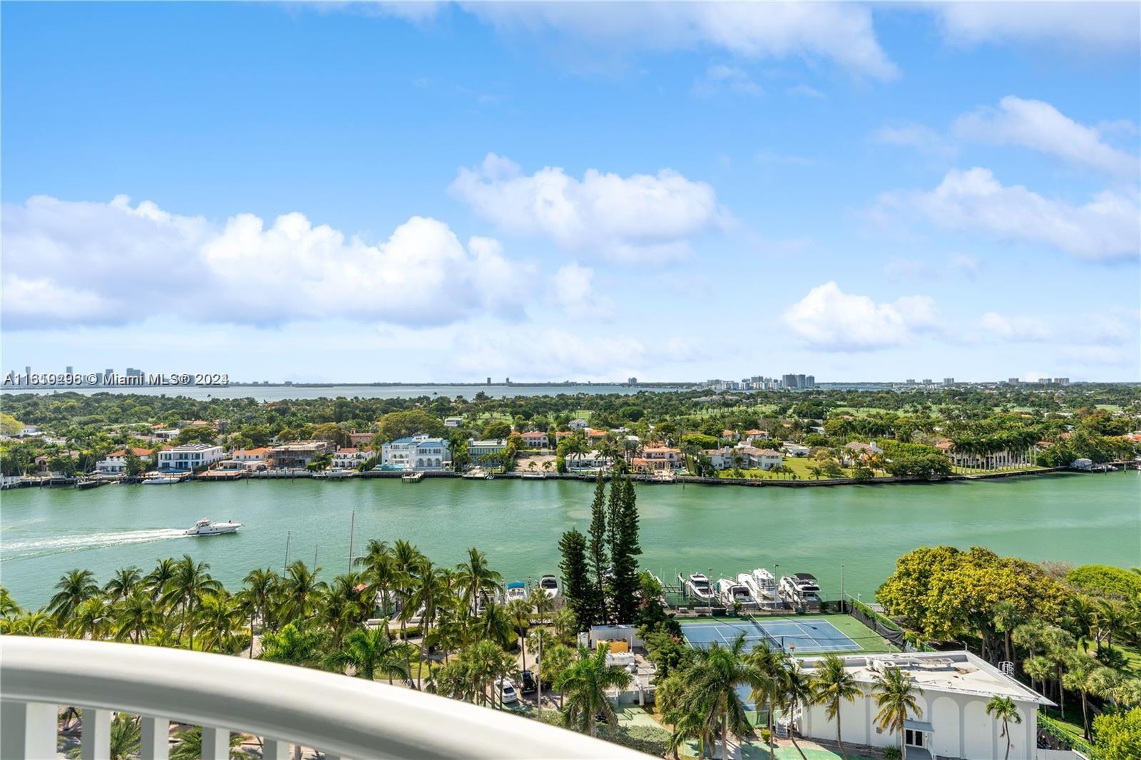 An elevated view shows a waterway, luxury homes, a tennis court, and boats — 5401 Collins Ave # 1123, Miami Beach FL 33140, MIAMI BEACH, FL