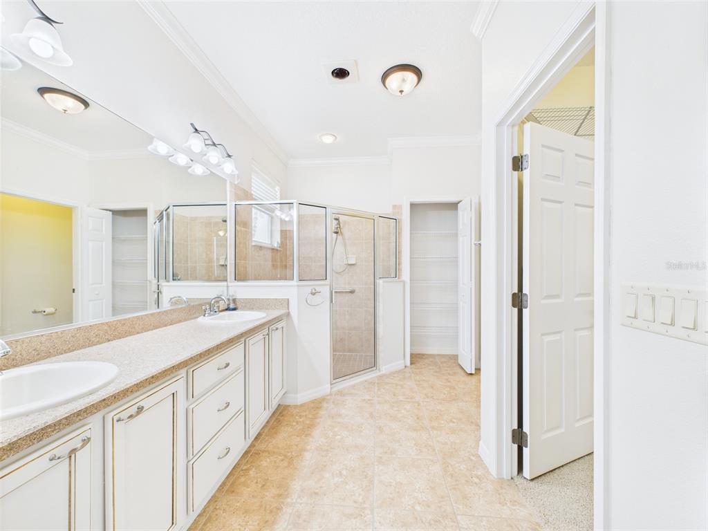 A kitchen features wood cabinets, stainless steel appliances, and a tiled backsplash — 375 SIMPSON STREET, THE VILLAGES, FL