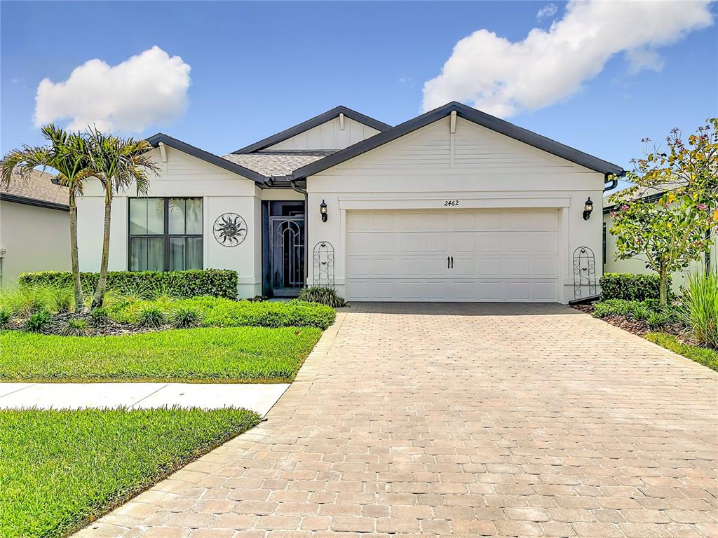 A single-story house with a white exterior, a two-car garage, and a paved driveway — 2462 GABEL OAK DRIVE, NORTH PORT, FL